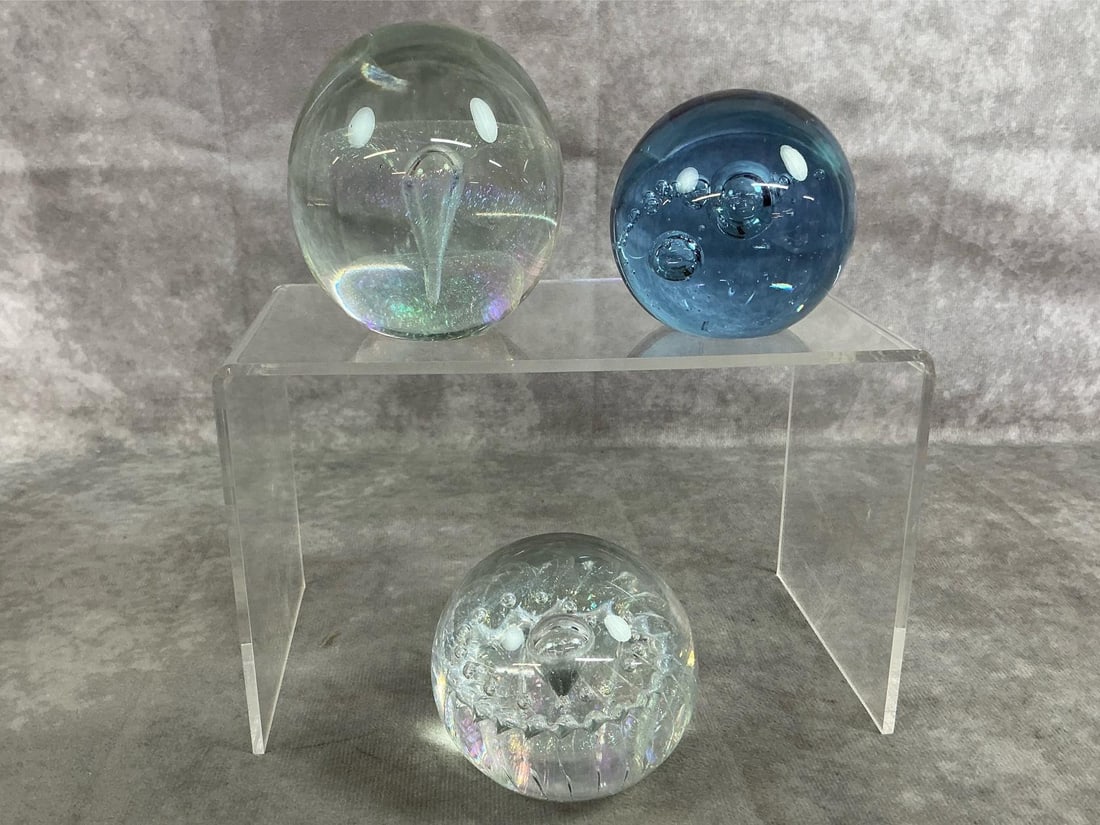 Collectible Crystal Paperweights: Three art glass paperweights from 1990's. Includes iridescent clear glass with flecks of color by Eickholt, blue crystal glass marked Mantorp Sweden, and bubble design clear glass by Maytum Studio.