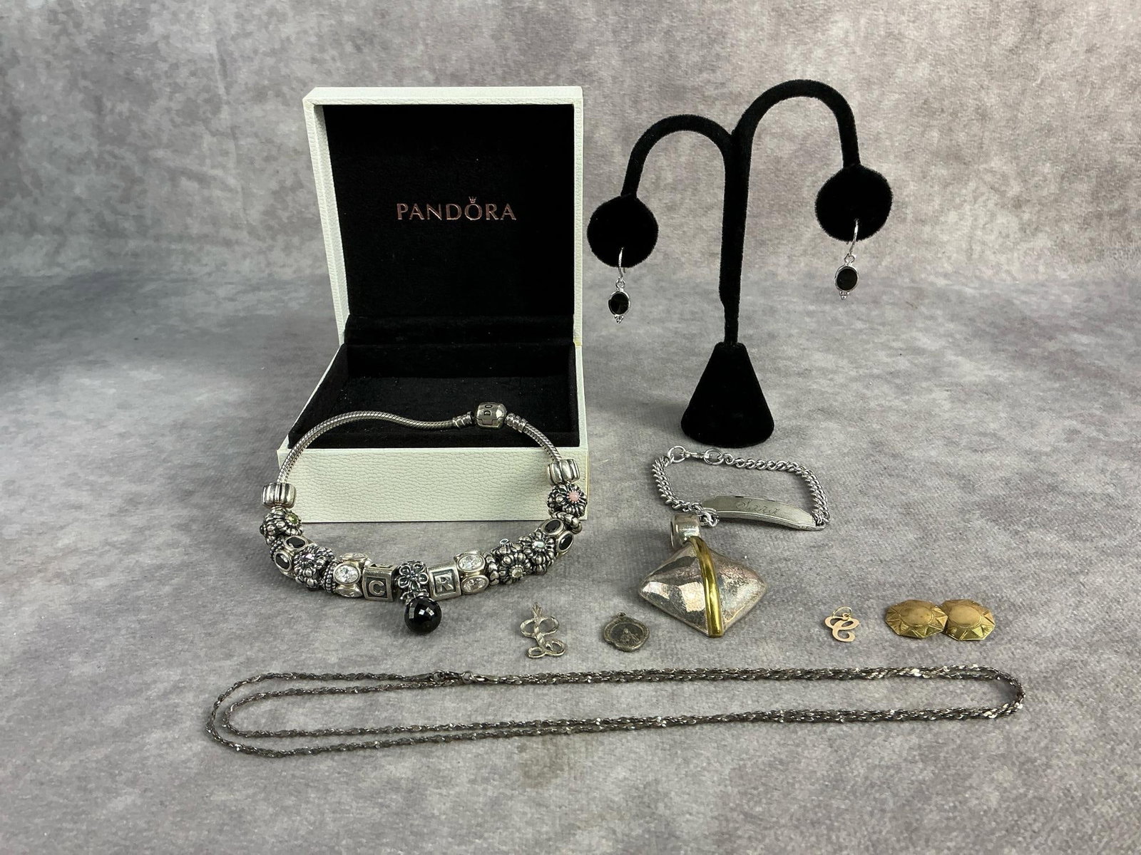 Gold & Silver Jewelry: Pandora bracelet with sterling silver charms, all but two charms are stamped S925. Large pendant marked Mexico 925, small St. Jude pendant, initial ""L" pendant, chain, and earrings all sterling