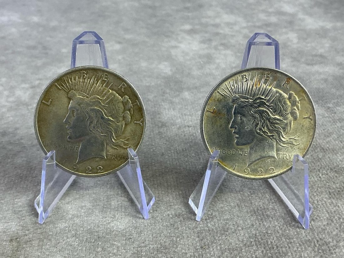 US Peace Dollars: Two 1922 United States Peace Dollars, silver coins that commemorate the end of World War I. Composed of 90 percent silver, in good circulated condition. Total weight 1.72 ozt.