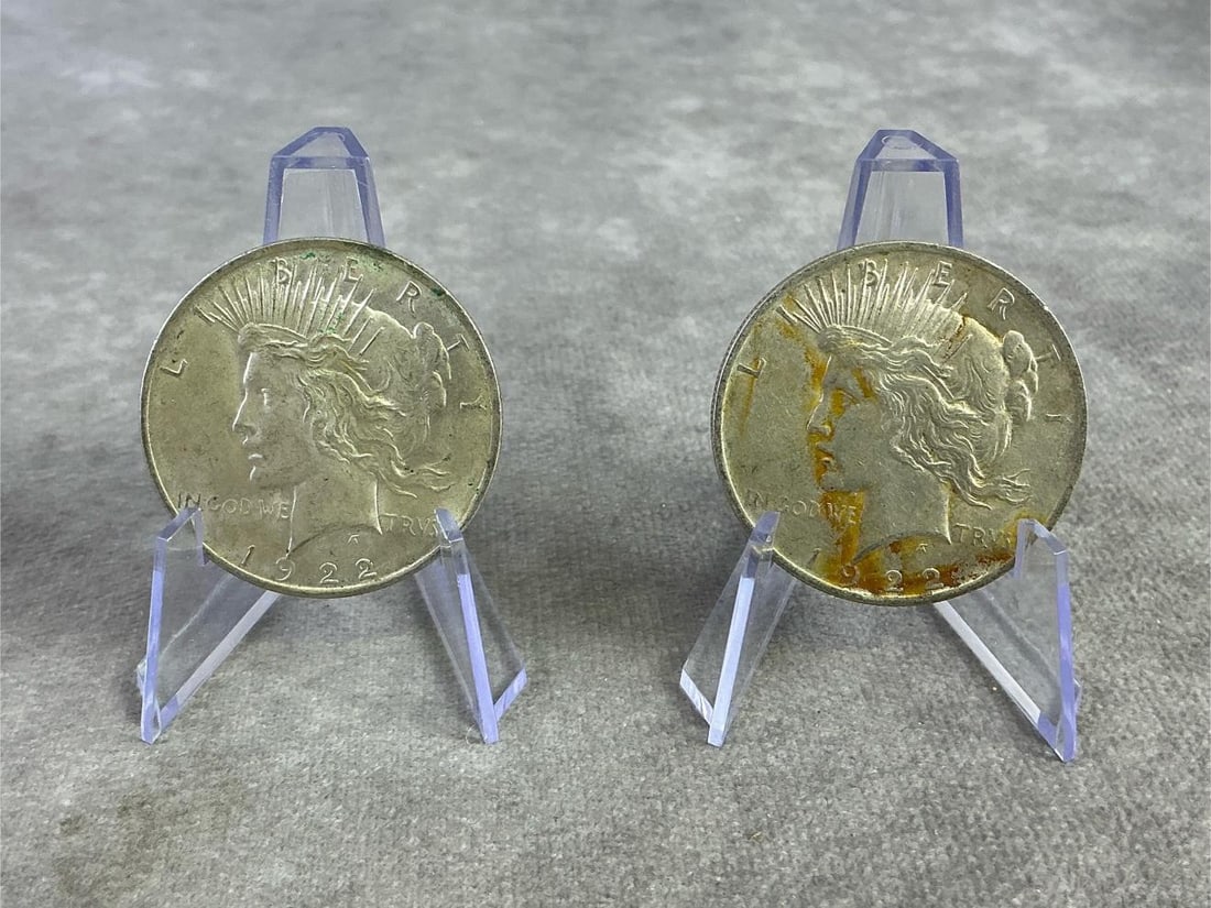 US Peace Dollars: Two 1922 United States Peace Dollars, silver coins that commemorate the end of World War I. Composed of 90 percent silver, in good circulated condition. Total weight 1.71 ozt.
