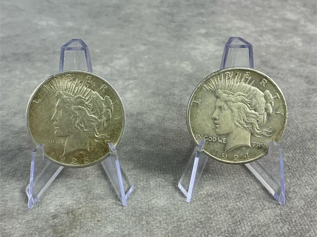 Peace Dollars: Two United States Peace Dollars from 1924 and 1925, silver coins that commemorate the end of World War I. Composed of 90 percent silver, in good circulated condition. Total weight 1.71 ozt.