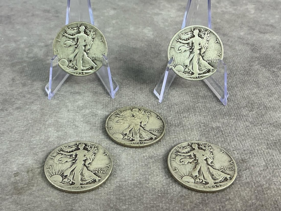 Walking Liberties: Five United States Walking Liberty Half Dollars dating from 1934 to 1944. All in good circulated condition. Total weight 1.96 ozt.