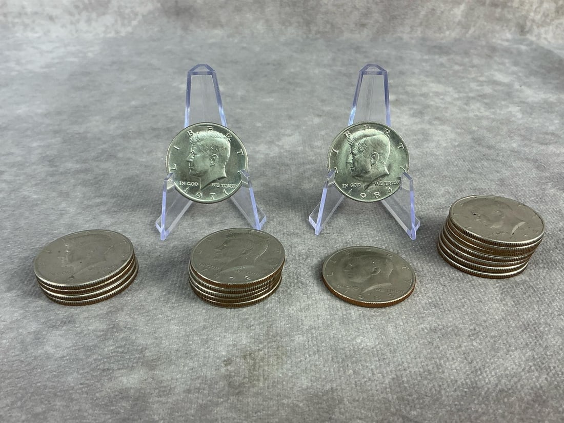 Kennedy Halves: Nineteen Kennedy Half Dollars ranging from 1971 to 1983. All in good circulated condition. Each measures 1.15 inches in diameter.