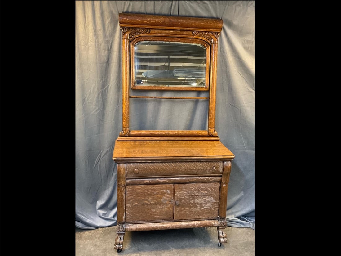 Victorian Oak Dresser: Late 19th / early 20th century Oak Dresser with mirror and one drawer over two doors on claw feet and castors. Broken drawer pull and some white discoloration to finish. Measures 38 inches wide x 21 x