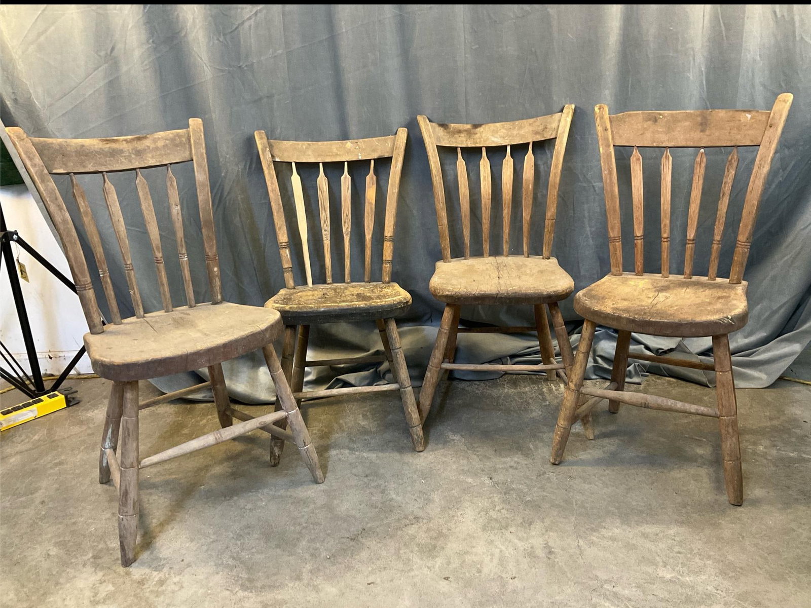 Set of Windsor Chairs: Circa 1830 set of four arrow back/thumb back plank bottom poplar Windsor Chairs with ""bamboo" turnings. Mid-Atlantic/Virginia. Signs of wear commensurate with age and use. Measures 14.5 inches wide