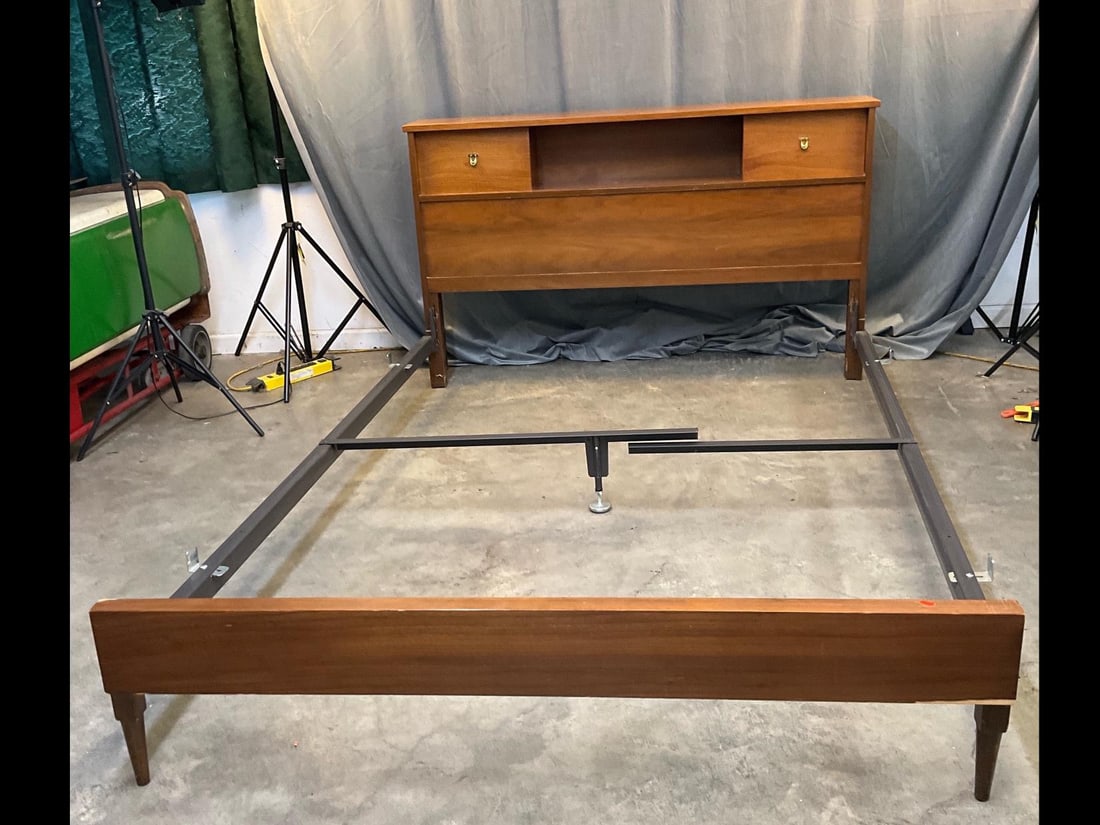 MCM Bed: Circa 1960's walnut bed with headboard storage shelves. Small areas of water damage to headboard top, otherwise good condition. Measures 58.75 inches wide x 94.5 x 35 inches tall.
