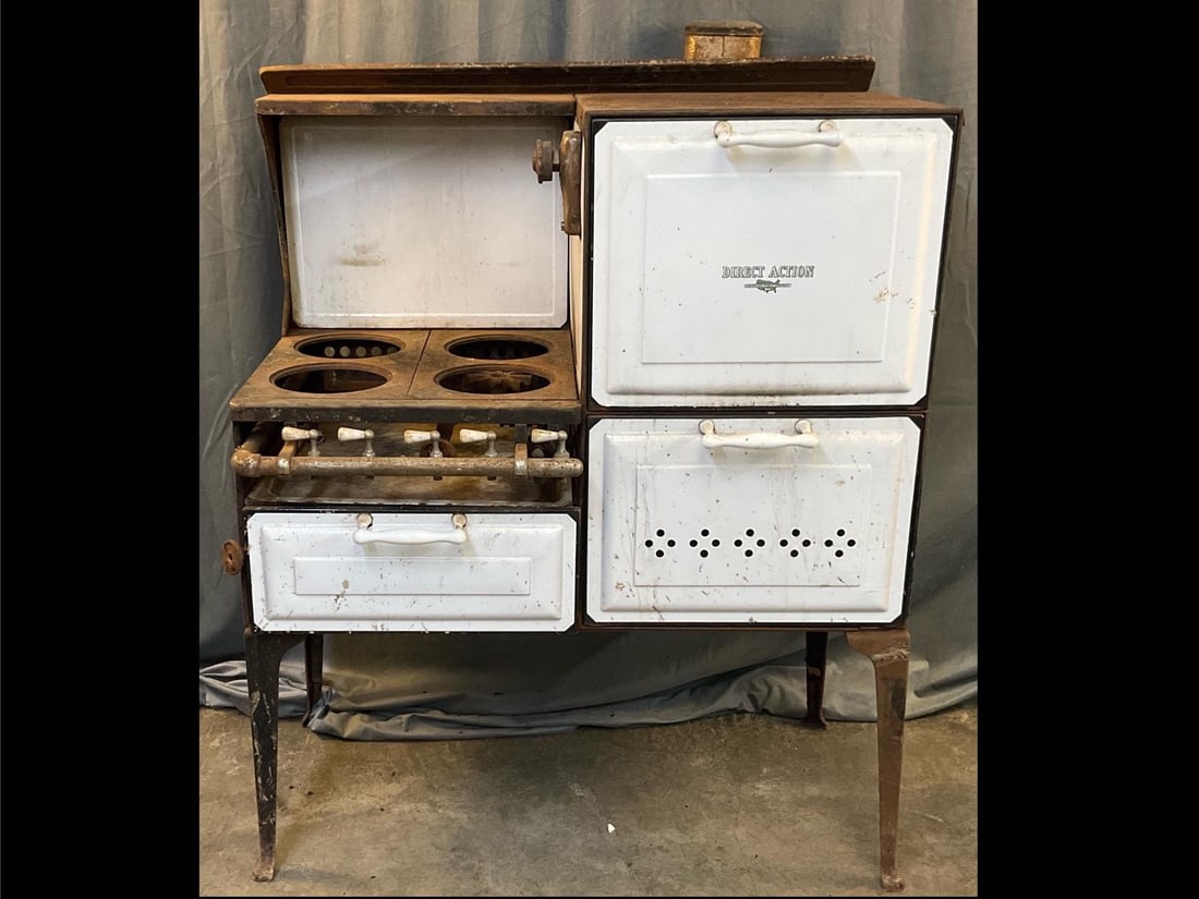 Porcelain Stove: Circa 1930 American Stove Company Direct Action porcelain four burner gas stove. Used condition, surface rust with general wear and weld repair to upper leg. Measures 40.5 inches wide x 21 x 53