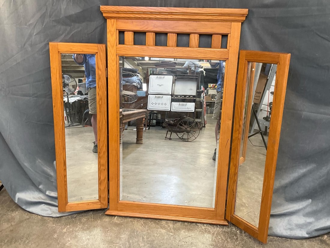 Folding Mirror: Contemporary folding three section dresser top or floor standing oak mirror. One blemish to silvering, otherwise good condition. Measures 52 inches wide x 2 x 48.75 inches tall.