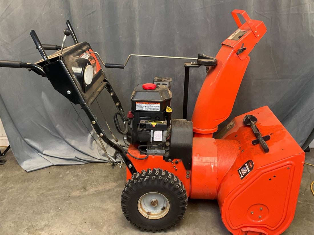Ariens Snowblower: Ariens Deluxe 27 Snowblower. 249cc OHV 1150 series dual-stage Briggs & Stratton engine, 27" clearing width, 120 volt/recoil starter. Used condition, not tested. Measures 60 inches wide x 28 x 43