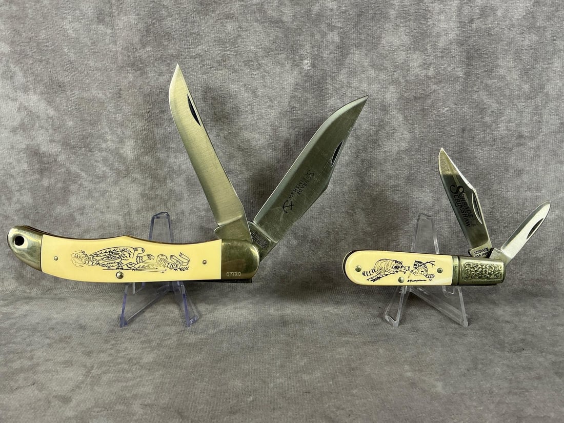 Schrade Knives: Two Scrimshaw Schrade pocket knives made in USA. Larger one has an eagle with Justice on it, number 07720, blade marked 261SC. Smaller one has raccoons with number 00902, blade marked SC506. Both