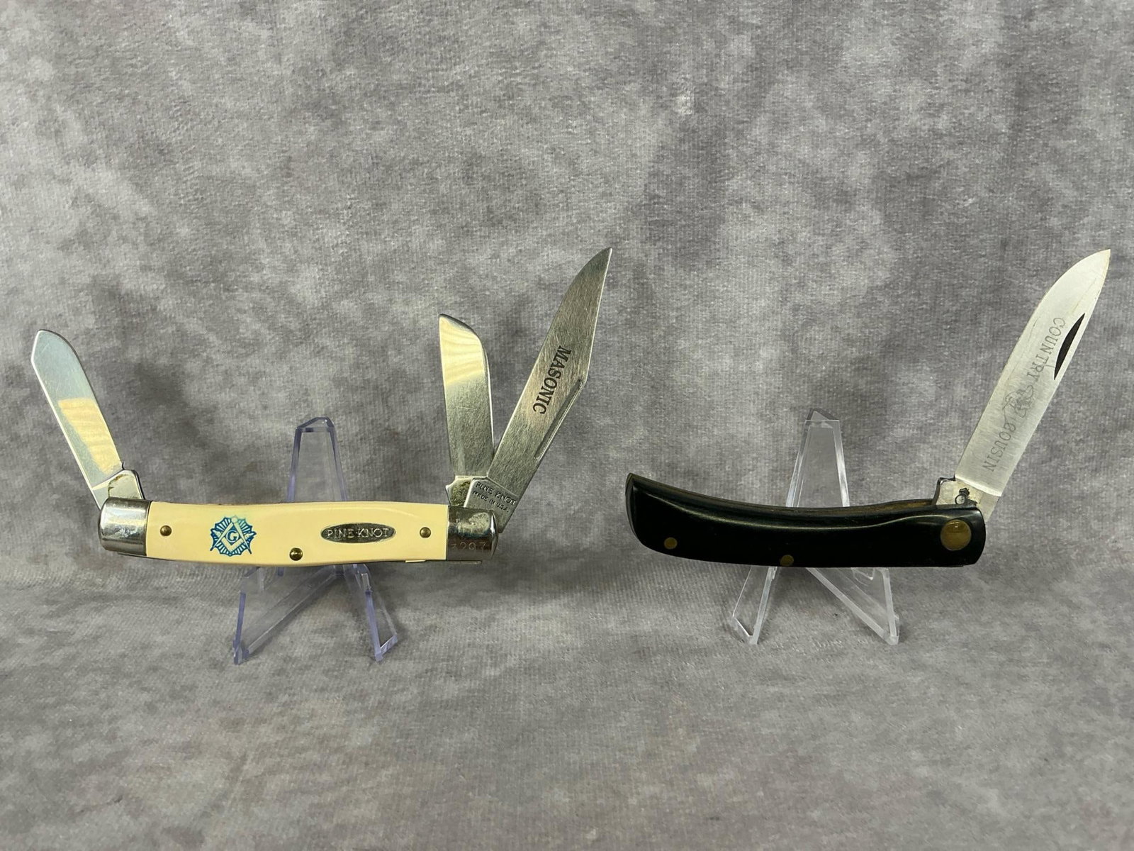 Pocket Knives: Masonic Pine Knot brand three blade pocket knife made in USA, number 3297. Queen Cutlery ""Country Cousin" single blade pocket knife made in USA. Both have never been sharpened and have a tight snap.