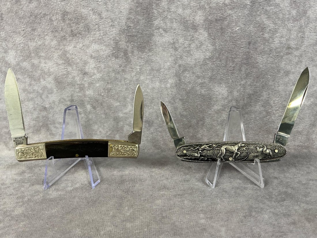 Pocket Knives: Two vintage pocket knives, Boker and United Cutlery. Boker with hunting scene on handle, blade marked Boker Solingen Germany Rostfrei. United Cutlery Rancher II, blade marked UC404 Surgical Steel