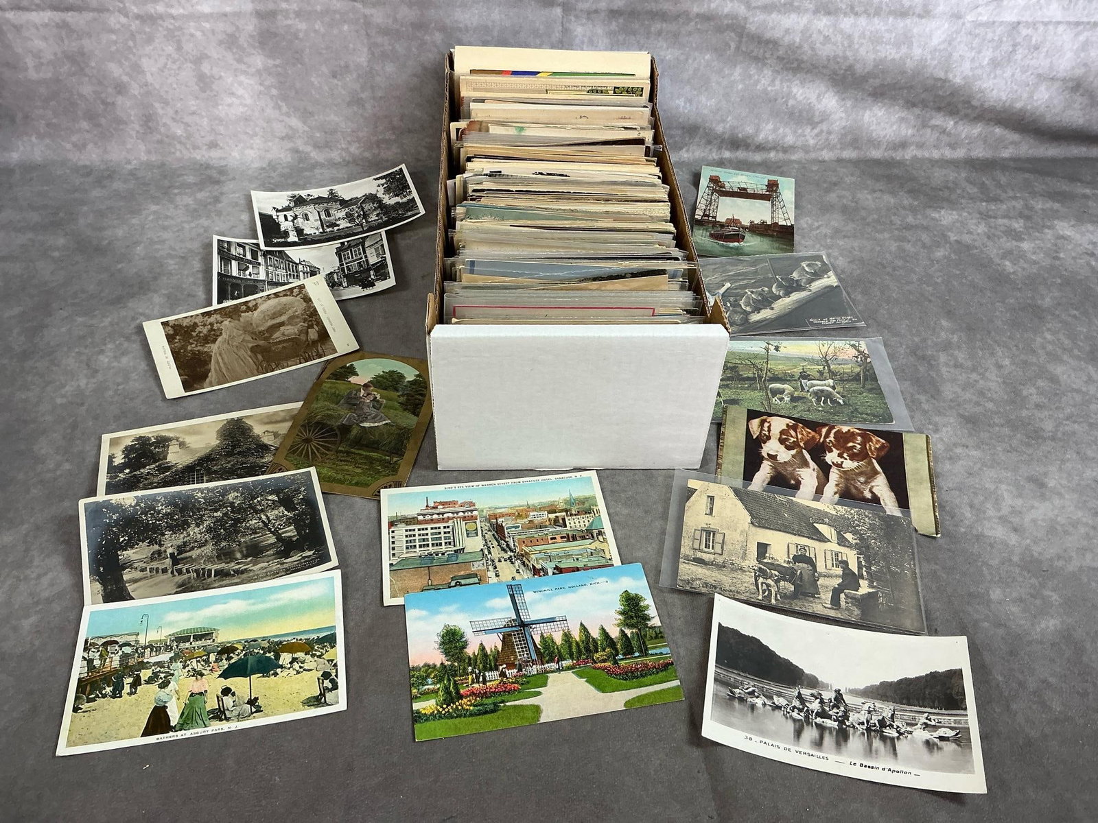 Postcards & Holiday Cards: Approximately 500 early to mid 1900's postcards and holiday greetings. Includes places, humorous cards, romance, animals, holiday, and more. Some are in clear sleeves. Cards show some wear and use.