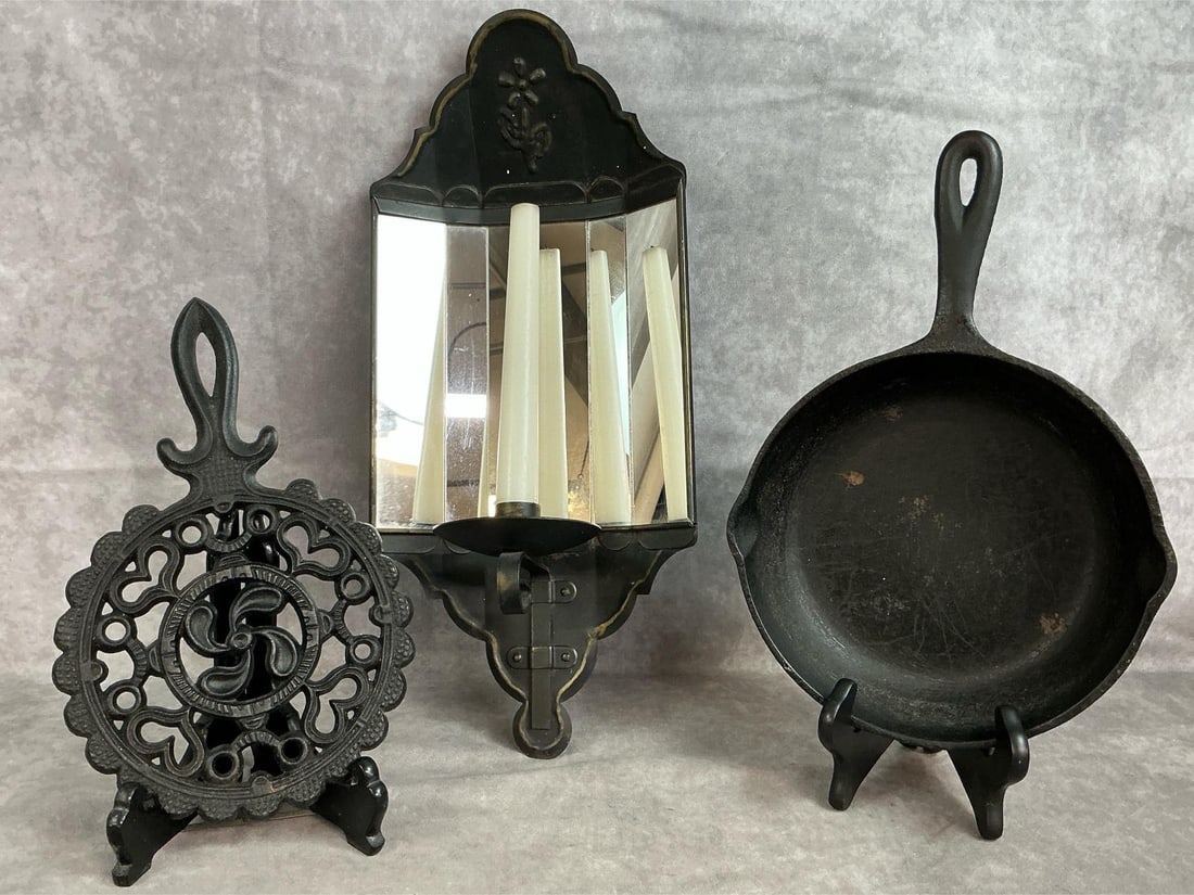 Cast Iron Skillet & Trivet and Tin Wall Sconce: Three mid 1900's items. Homeco wall sconce with mirrored reflection panels, 8.5 inch cast iron skillet and scalloped edge cast iron trivet. Skillet has small amount of rust, otherwise items in good co