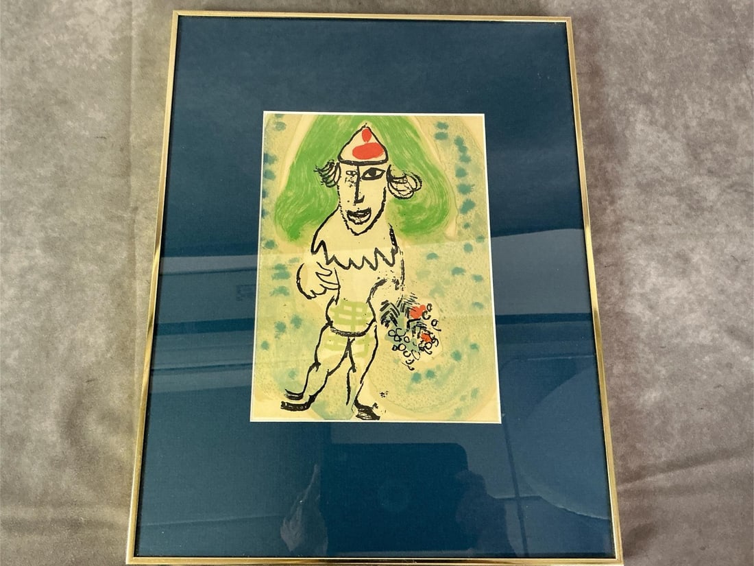 Collectible "Green Clown": Marked 1955 "The Green Clown" lithograph by Marc Chagall. Matted in blue with metal gold tone frame. In good condition. Measures 13.25 inches wide x .75 x 17 inches tall.