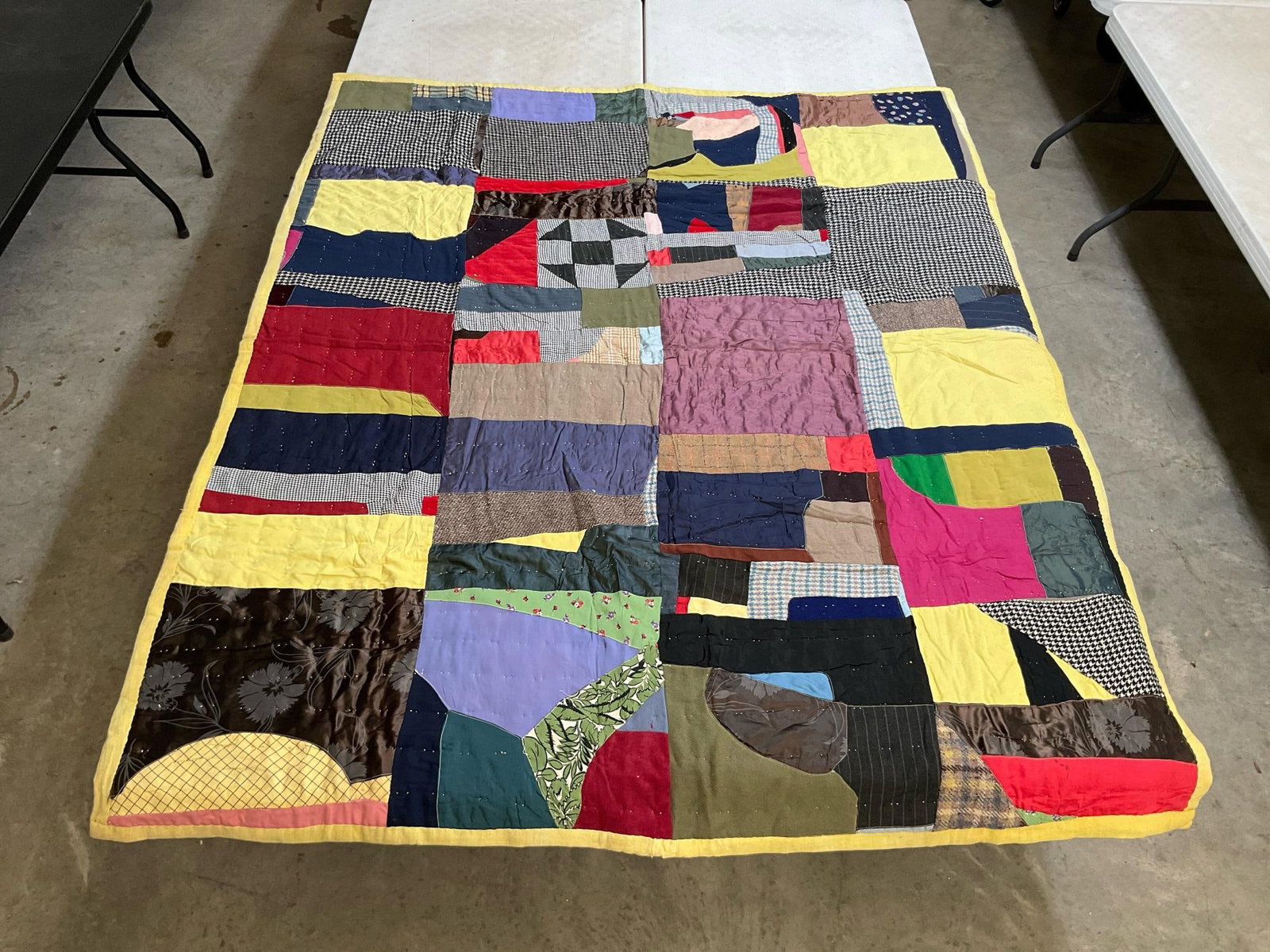 Crazy Quilt: Vintage homemade crazy quilt, machine stitched and hand quilted. Backing is feedsack material from Roanoke Virginia. A couple stains on the back, otherwise in good condition. Measures 62 inches wide