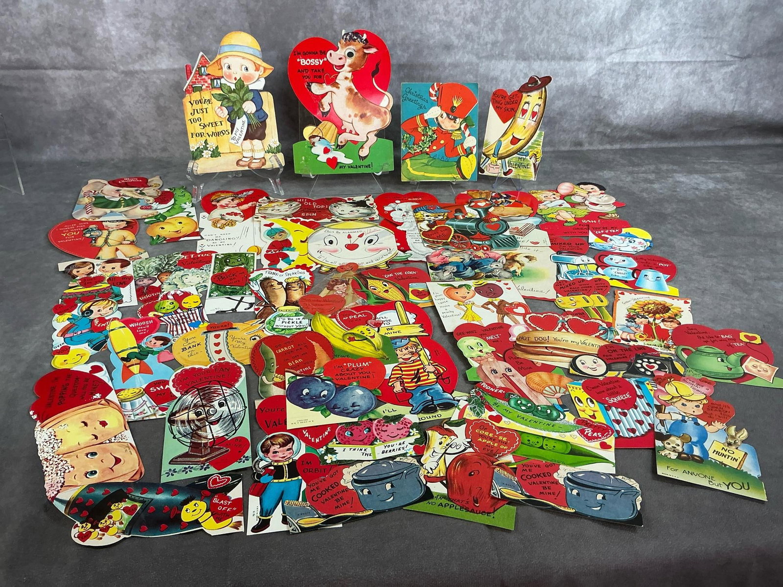 Vintage Valentines & Holiday Cards: Fifty vintage Valentine cards, children's Christmas cards and Easter. Some have names on back. In good condition. Largest measures 5.5 inches wide x 7.5 inches tall.