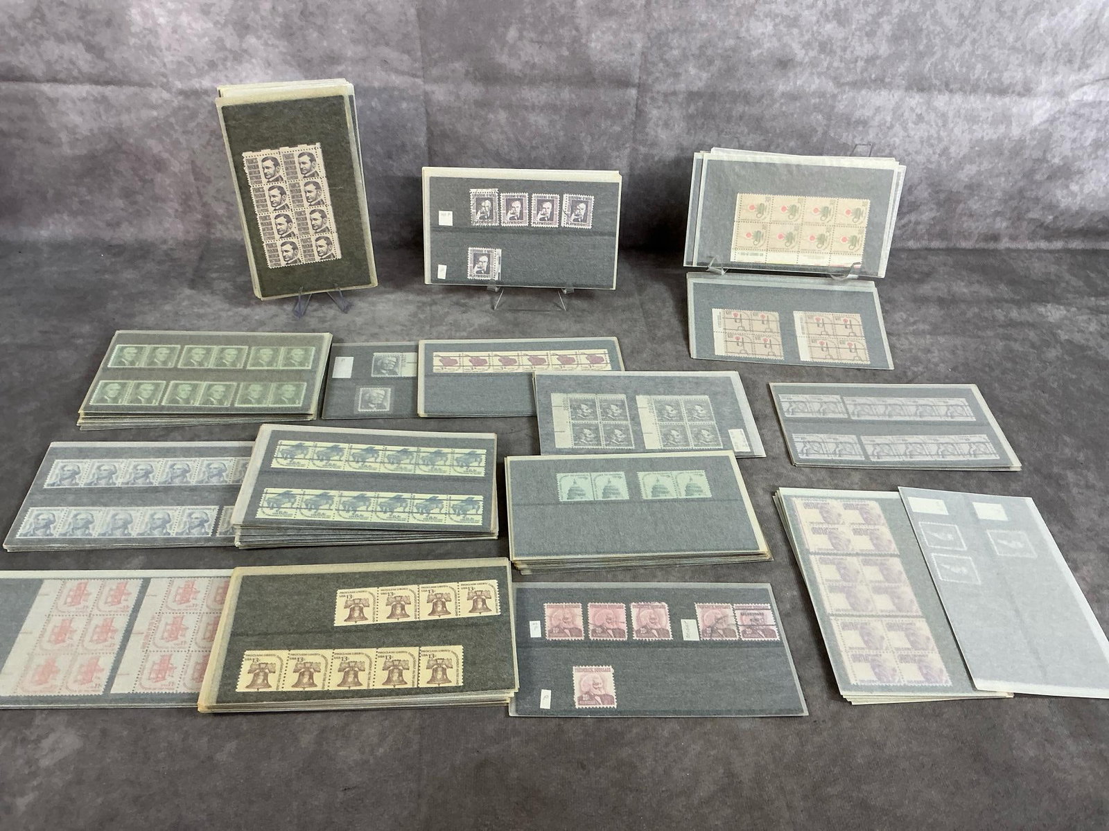United States Postal Stamps: Large collection of varied denominations of vintage postal stamps. A few are postmarked, most are unused. Includes sixty $2 stamps, forty-eight $1 stamps, and multiple 1cent, 2cent, 3cent, 4cent,