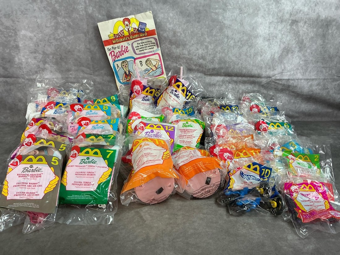 Happy Meal Barbie & HotWheels Toys: Twenty 2000 McDonald's Barbie figures. Twenty-six 2000 year HotWheels assortment toys. In original packaging. Average measures 4 inches wide x 6.5 inches tall.