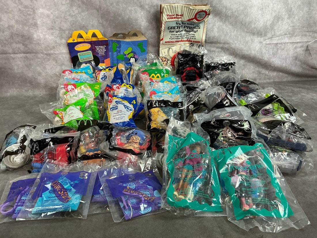 McDonald's Happy Meal Toys: Forty-five 2001-2006 Happy Meal toys. Includes Spy Kids, Disney Characters, Diva Starz, and Cartoon toys. In original packaging. Measures 4 inches wide x 5 inches tall.