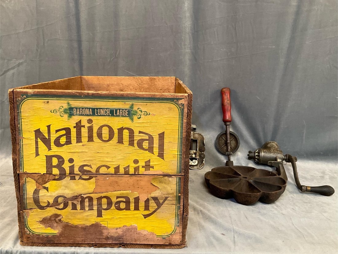 Biscuit Box and Implements: Miscellaneous early 20th century implements. Hand drill, Universal Food Chopper, clamp, cast iron mold and National Biscuit Company wooden box with partial advertising lithograph. Used condition. Box