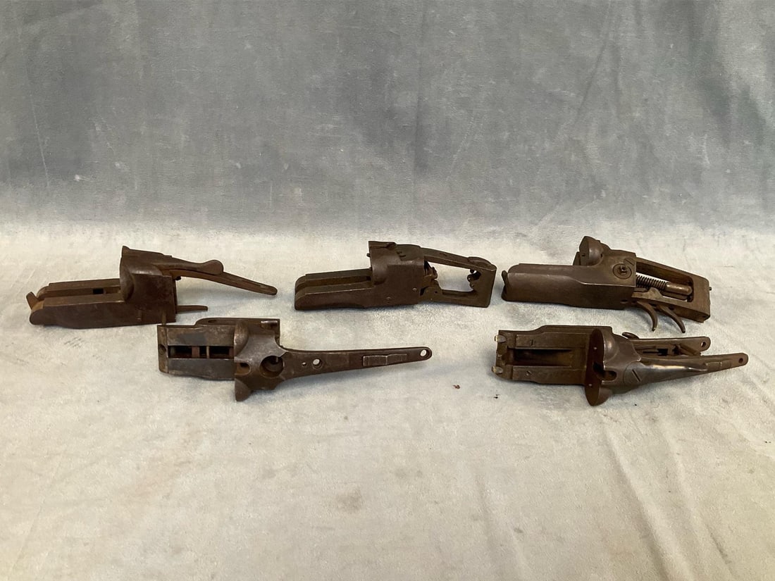 Shotgun Receivers: Five early 20th century side by side 12 gauge receivers. One receiver marked Ithaca Gun Company 274440. One receiver marked Stevens Gun Company 1915 patent applied for. One receiver marked Wiltshire