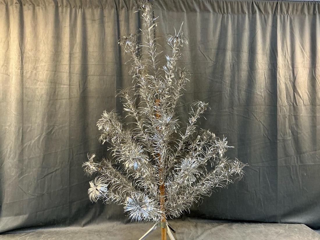 Vintage Silver Christmas Trees: Two mid 1900's stainless aluminum Christmas trees. Trees have stands, center pole, and individual branches that insert in tree trunk. Box is worn, otherwise in good condition. Both are four foot tall 