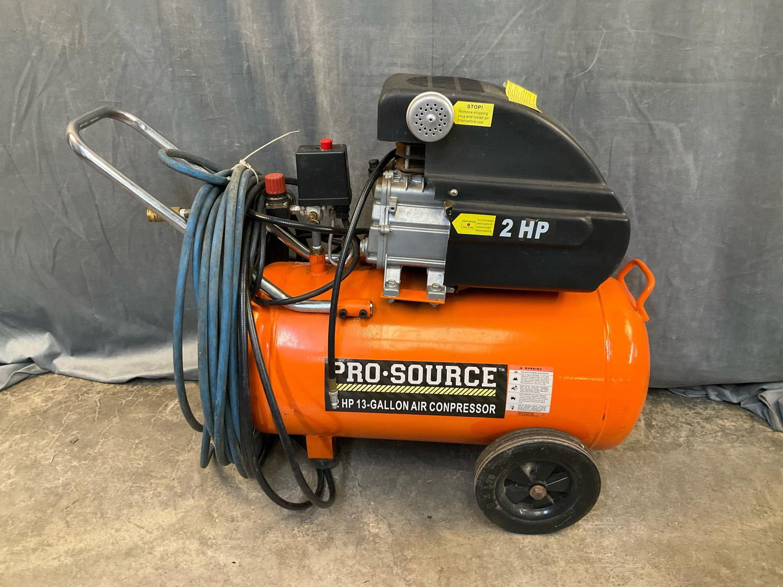 Air Compressor: Pro Source Model 113C, 2 HP, 13 Gallon Portable Air Compressor. Tested and works. Measures 36 inches wide x 15 x 27.25 inches tall.