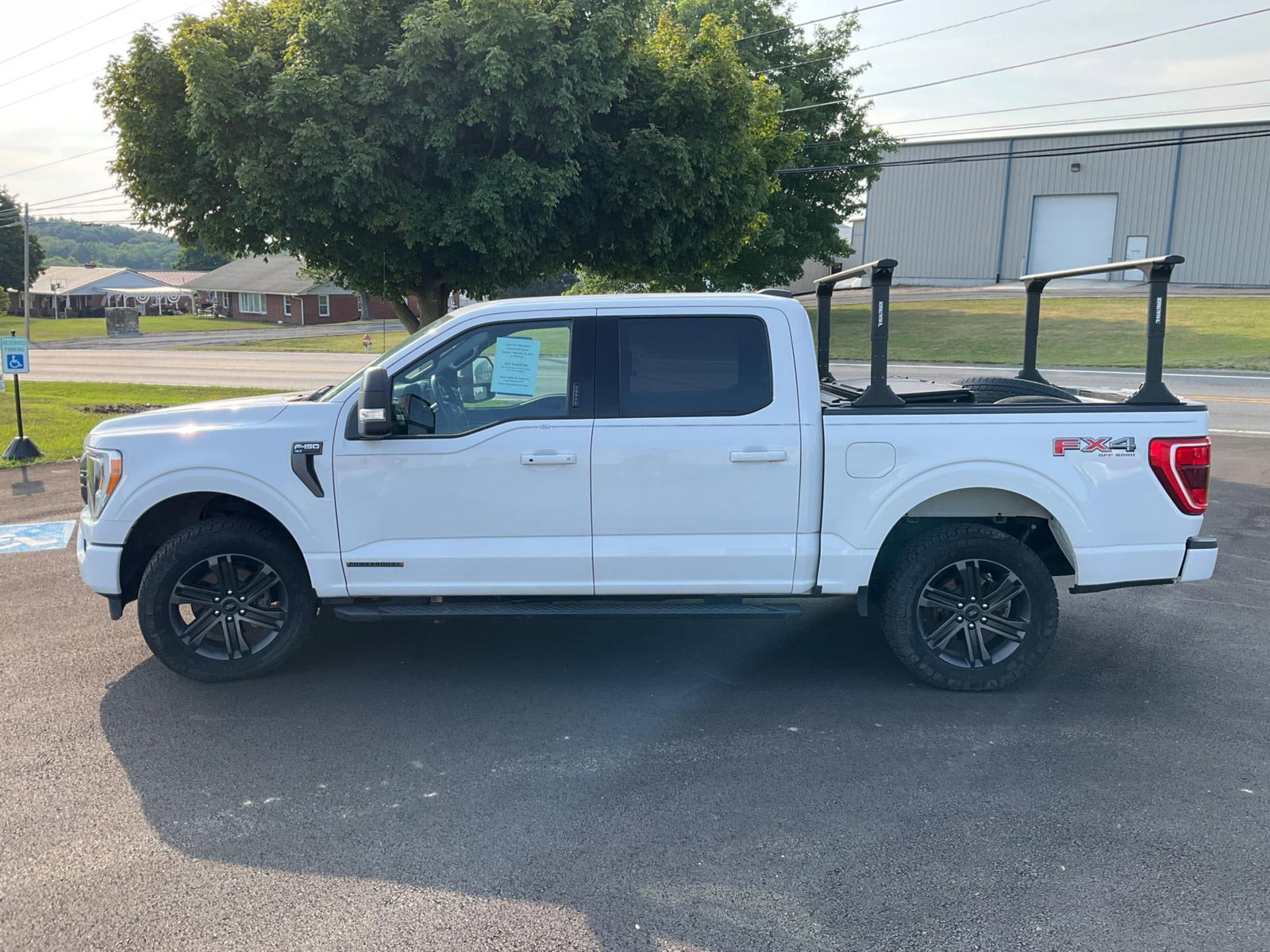 2021 Ford F150 Hybrid: 2021 Ford F150 4WD white pickup truck with crew cab, with 83,611 miles. Remote keyless entry, remote start, power windows and door locks, touch display screen in dash, digital odometer, manual
