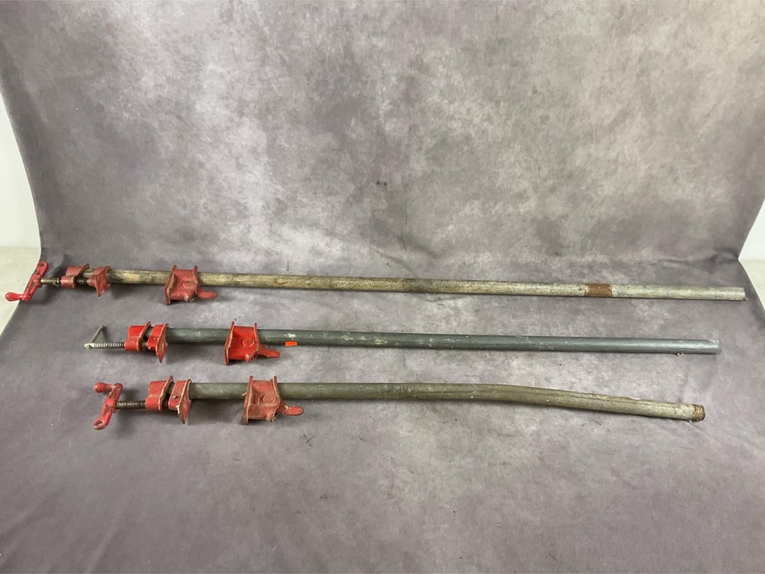 Pipe Clamps: Three adjustable pipe clamps. One 4 foot, one 42 inches, and one 3 foot capacity. Used, one bent otherwise in good condition. Largest measures 56 inches long X 4 inches wide X 2 inches high.