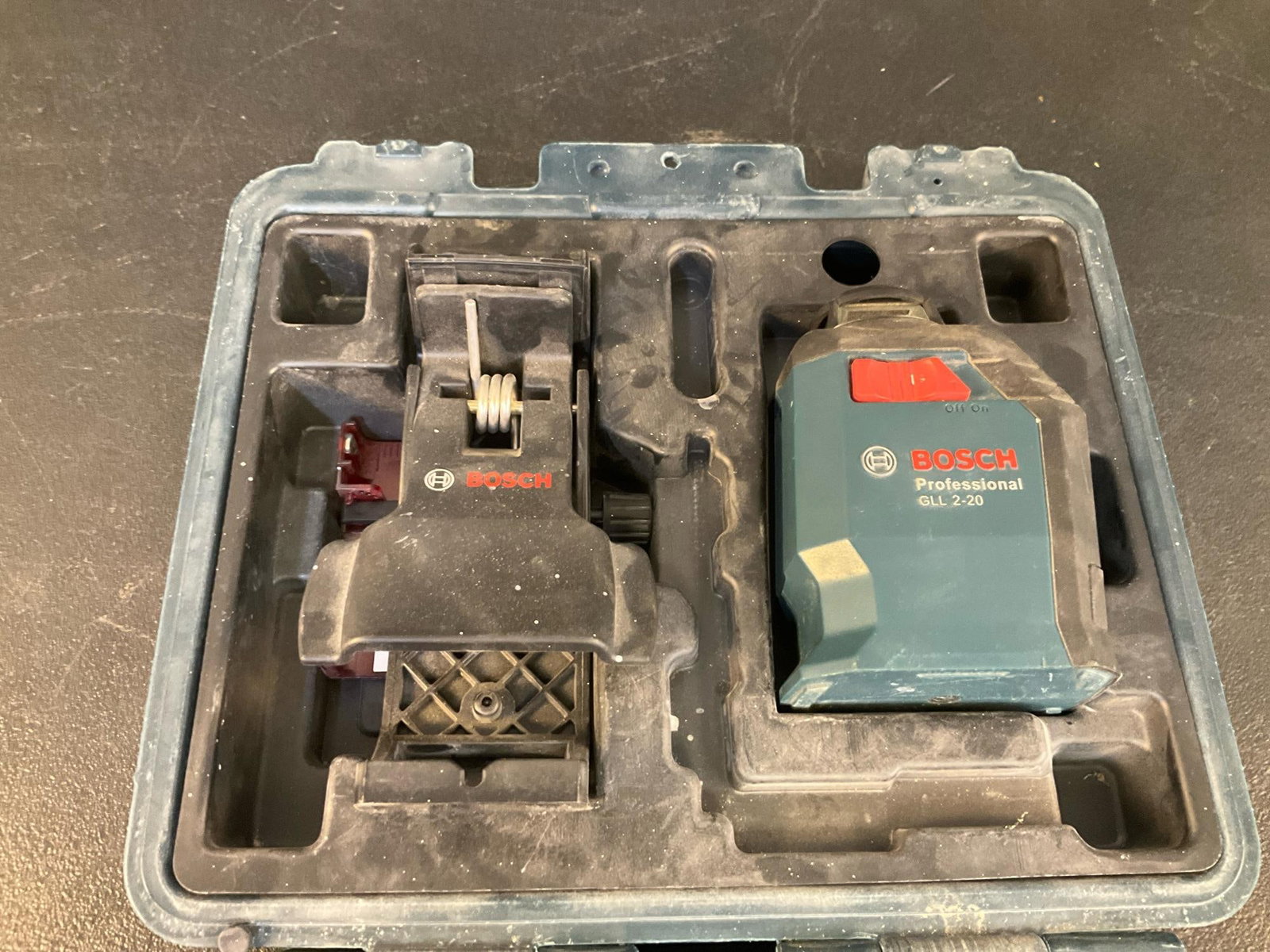 Bosch Laser: Bosch GLL2-20-RT self-leveling 360 degree line and cross laser. Used condition, not tested. Measures 11 inches wide x 4.25 x 10.25 inches tall.