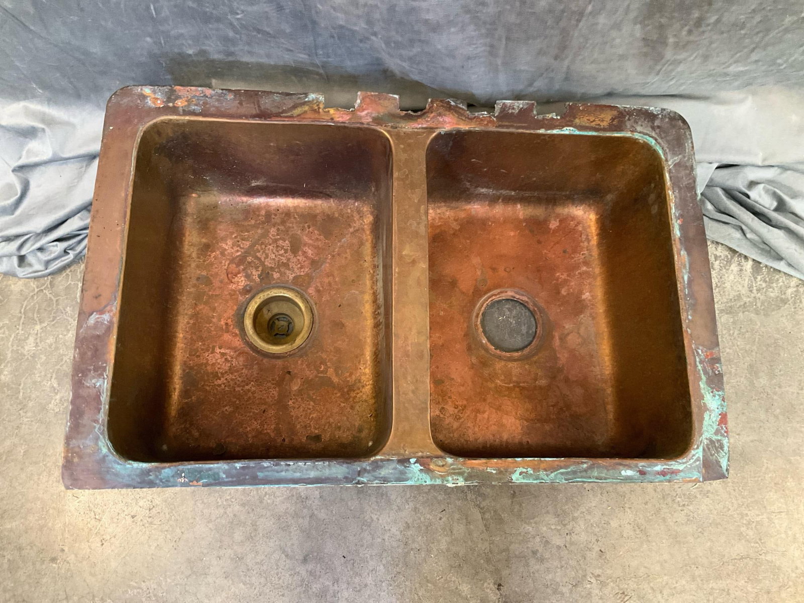 Copper Sink: Copper double sink. Used condition, dents and tarnishing. Measures 33 inches wide x 21.5 x 9 inches tall.