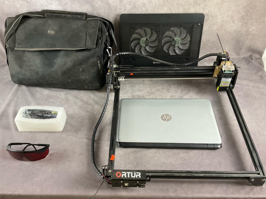 Ortur Laser Cutter: Ortur laser master 2. CNC laser engraver and cutter, includes HP laptop and accessories. Wood, leather and acrylic working material. Used and untested. Measures 22 inches long X 22 inches wide X 8