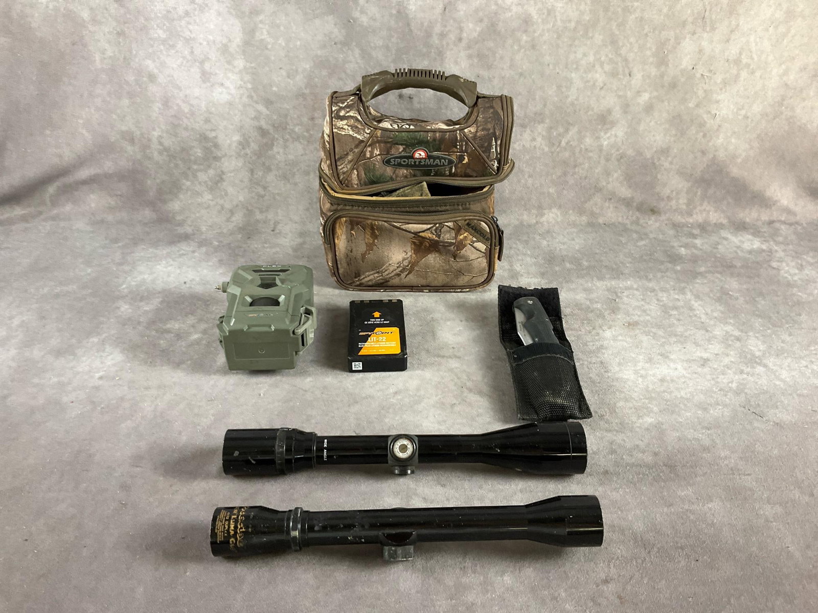 Trail Camera & Scopes: SpyPoint trail camera no charger. Bushnell 4 X 38 and Precise Valor 4 X 32 rifle scopes. Gerber knife and camo lunch box. All used and in good shape. Box measures 9 inches long X 6 inches wide X 11