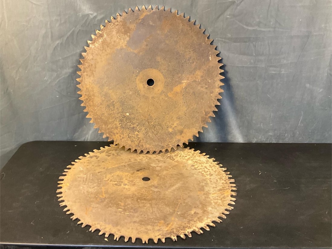 Sawmill Blades: Two vintage sawmill circular buzz blades. Used condition with surface rust. Measures 29.25 inches in diameter.