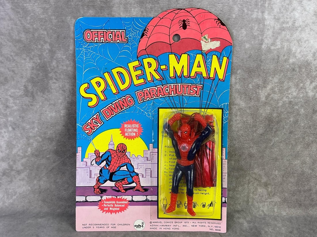 Spiderman Parachutist: 1973 Spider-Man sky diving parachutist made by Marvel Comics Group, Hong Kong. In original sealed packaging with mild bowing and a creased corner. Measures 7.5 inches wide x 10.5 inches tall.