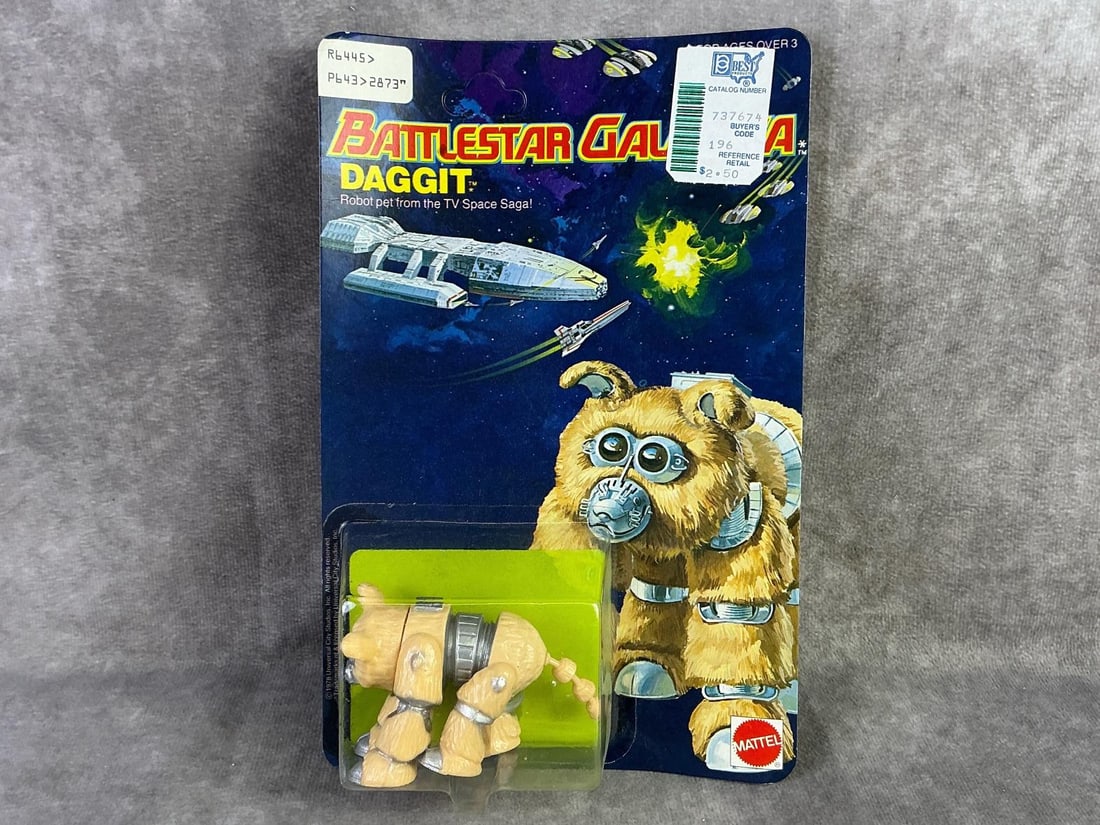 Battlestar Galactica: 1978 Daggit figure from Battlestar Galactica made by Mattel, Hong Kong. In original sealed packaging and unpunched. Some mild bowing to cardboard. Measures 5.75 inches wide x 8.75 inches tall.