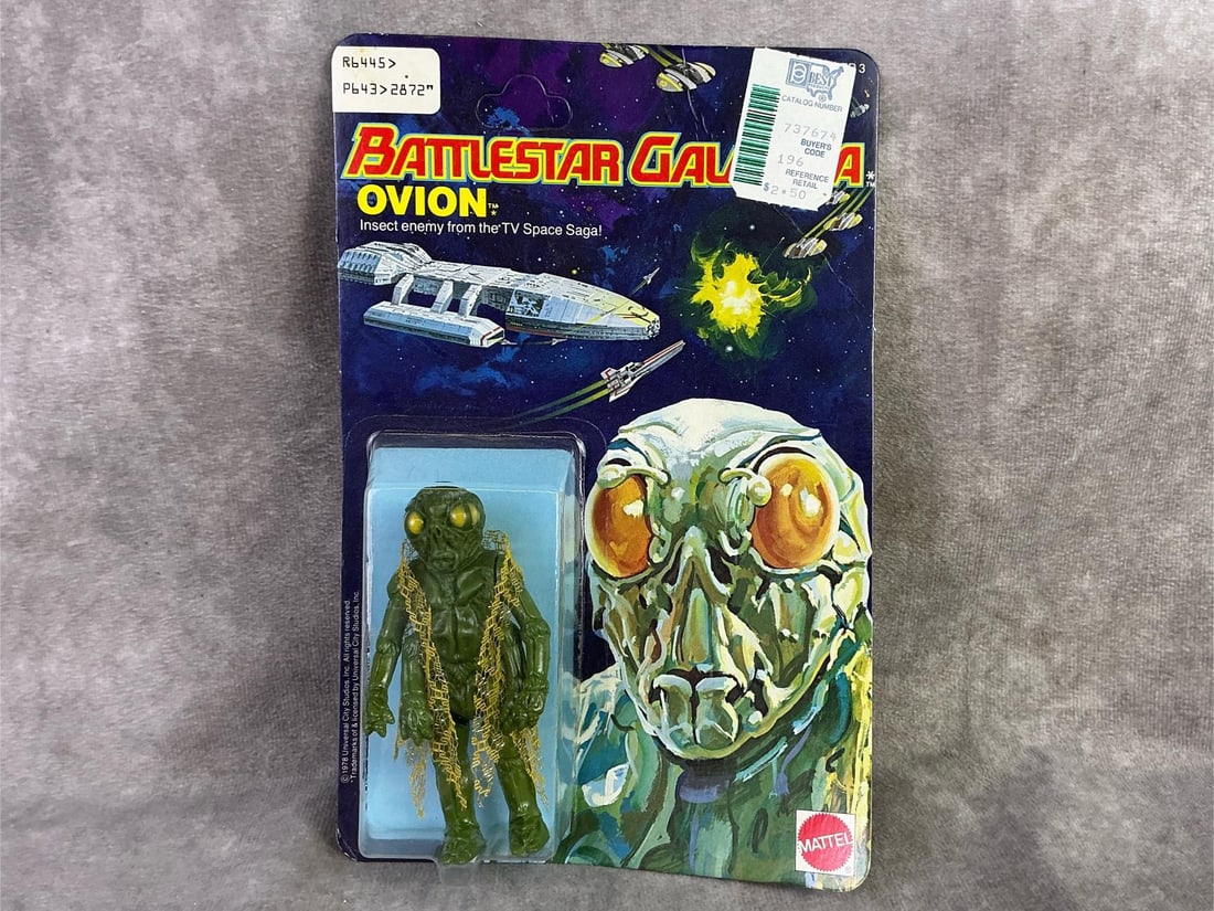 Battlestar Galactica: 1978 Ovion figure from Battlestar Galactica made by Mattel, Hong Kong. In original sealed packaging and unpunched. Some mild bowing to cardboard. Measures 5.75 inches wide x 8.75 inches tall.