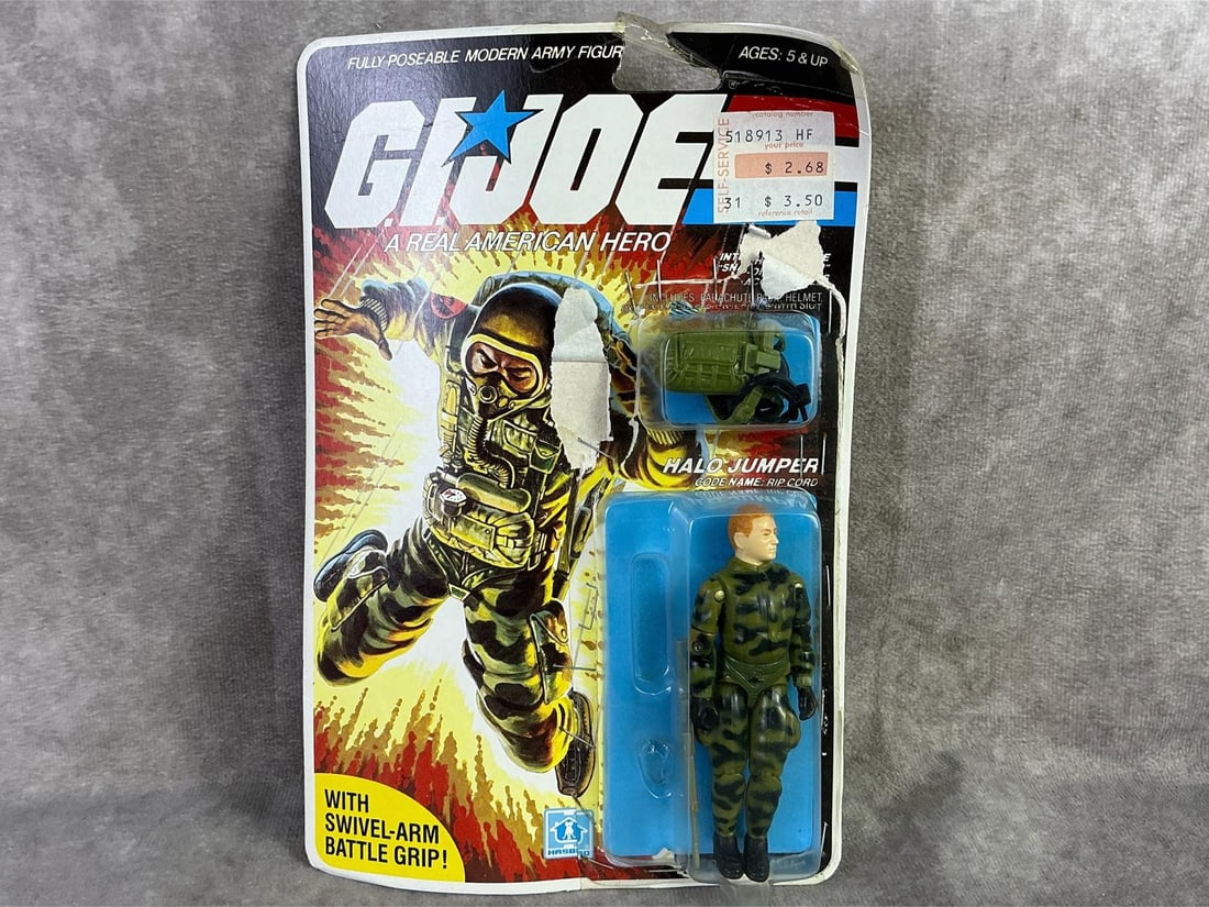Halo Jumper GI Joe: 1983 GI Joe, Halo Jumper figure made by Hasbro, Hong Kong. In original packaging with bowing present, staples and scotch tape to secure closed and cardboard peeling. Measures 6 inches wide x 9 inches