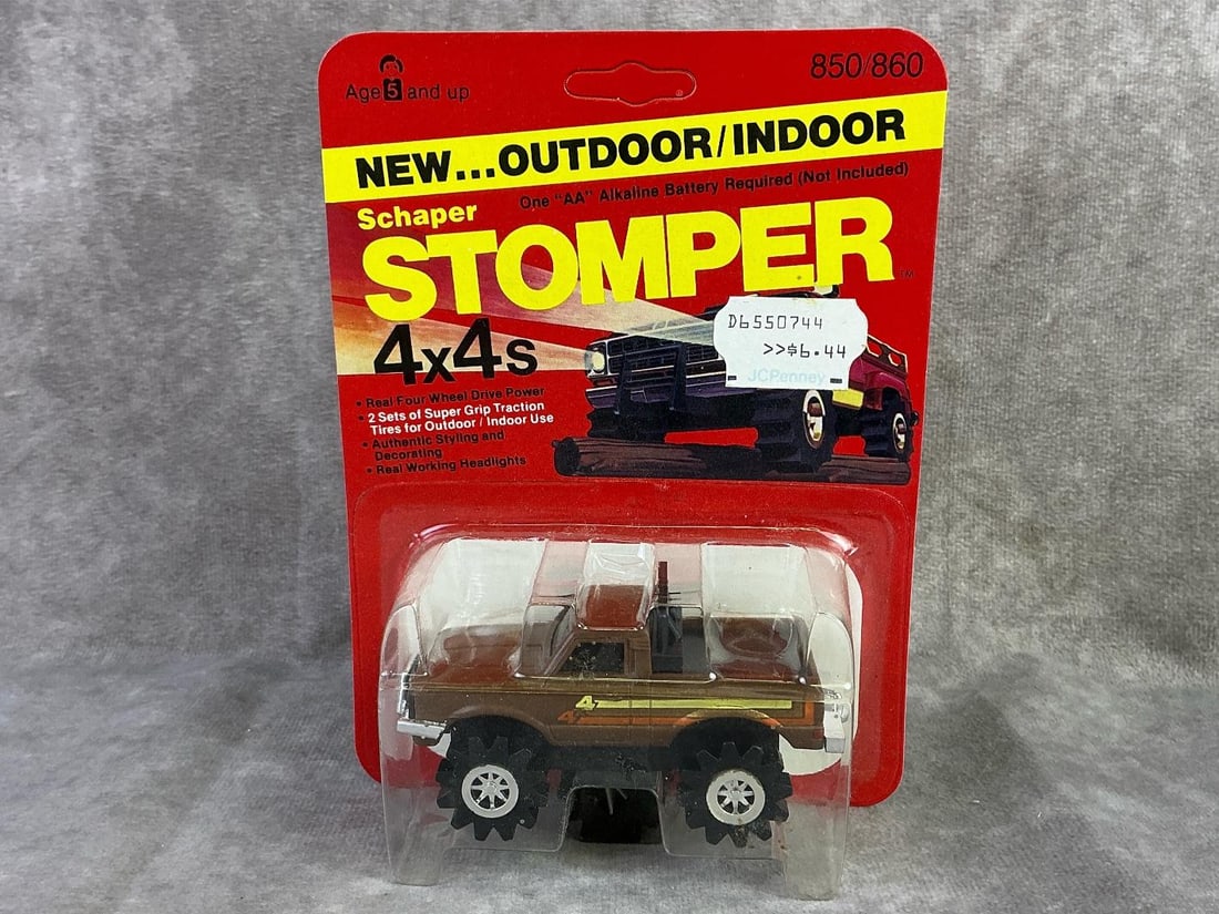 Schaper Stomper: 1980 Datsun Lil Hustler car made by Schaper, Hong Kong. In original sealed packaging with mild bowing to cardboard and unpunched. Measures 4.75 inches wide x 6.5 inches tall.