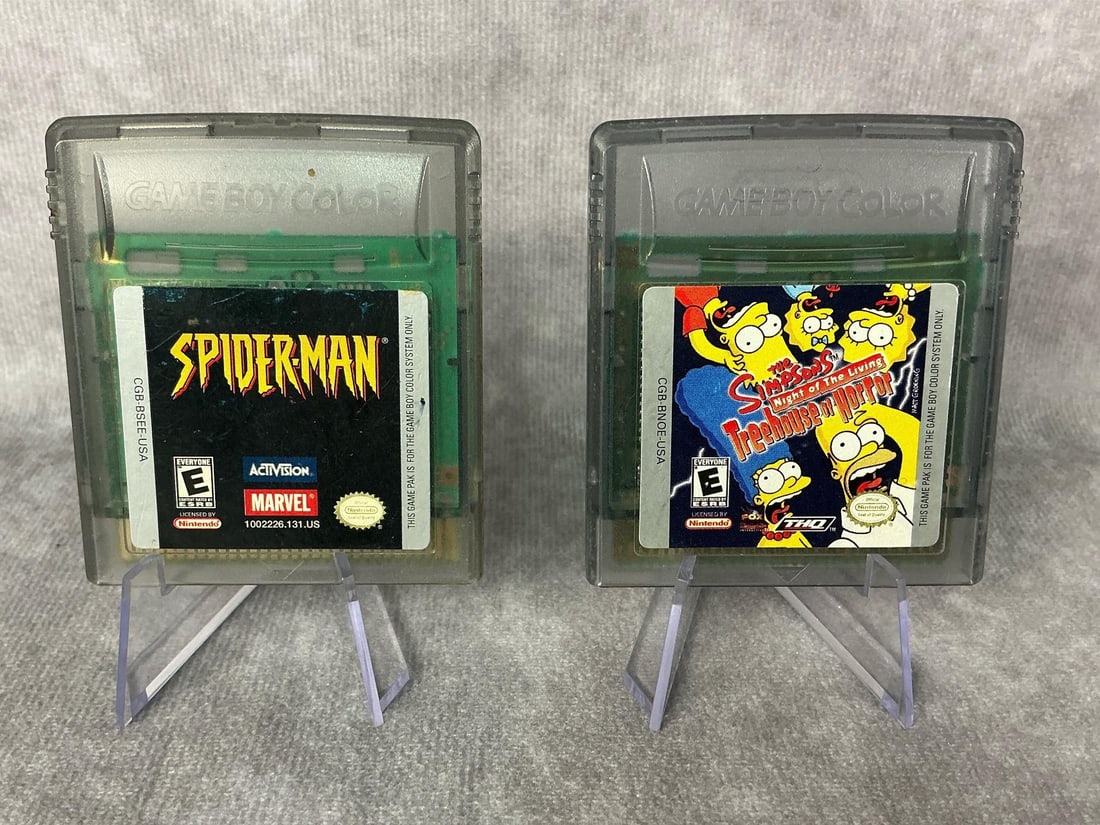 Game Boy Color Games: Two 1998 Game Boy Color games, Spider-Man and The Simpsons Treehouse of Horror Night of the Living. Both games are untested, in good condition, and measure 2.25 inches wide x 2.5 inches tall.