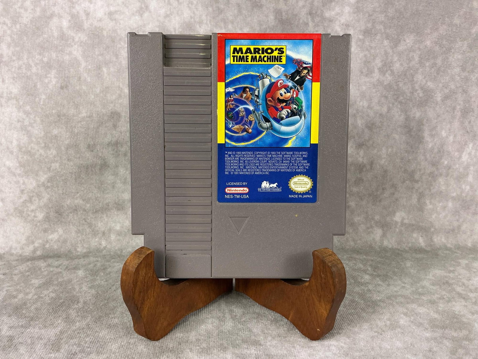 Nintendo NES Game: 1993 Mario’s Time Machine Nintendo Game, made in Japan. Untested, stickers on the back. Measures 4.75 inches wide x 5.25 inches tall.