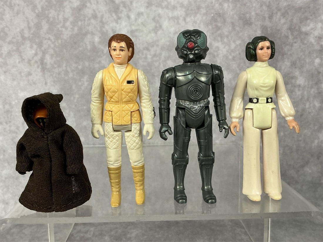 Star Wars Action Figures: Four 1977-1982 Star Wars action figures. Includes 1977 Princess Leia Organa missing cape and a 1977 Jawa with cloth cape, both made by GMFGI in Hong Kong. 1980 Princess Leia Hoth and a 1982 Zuckuss,