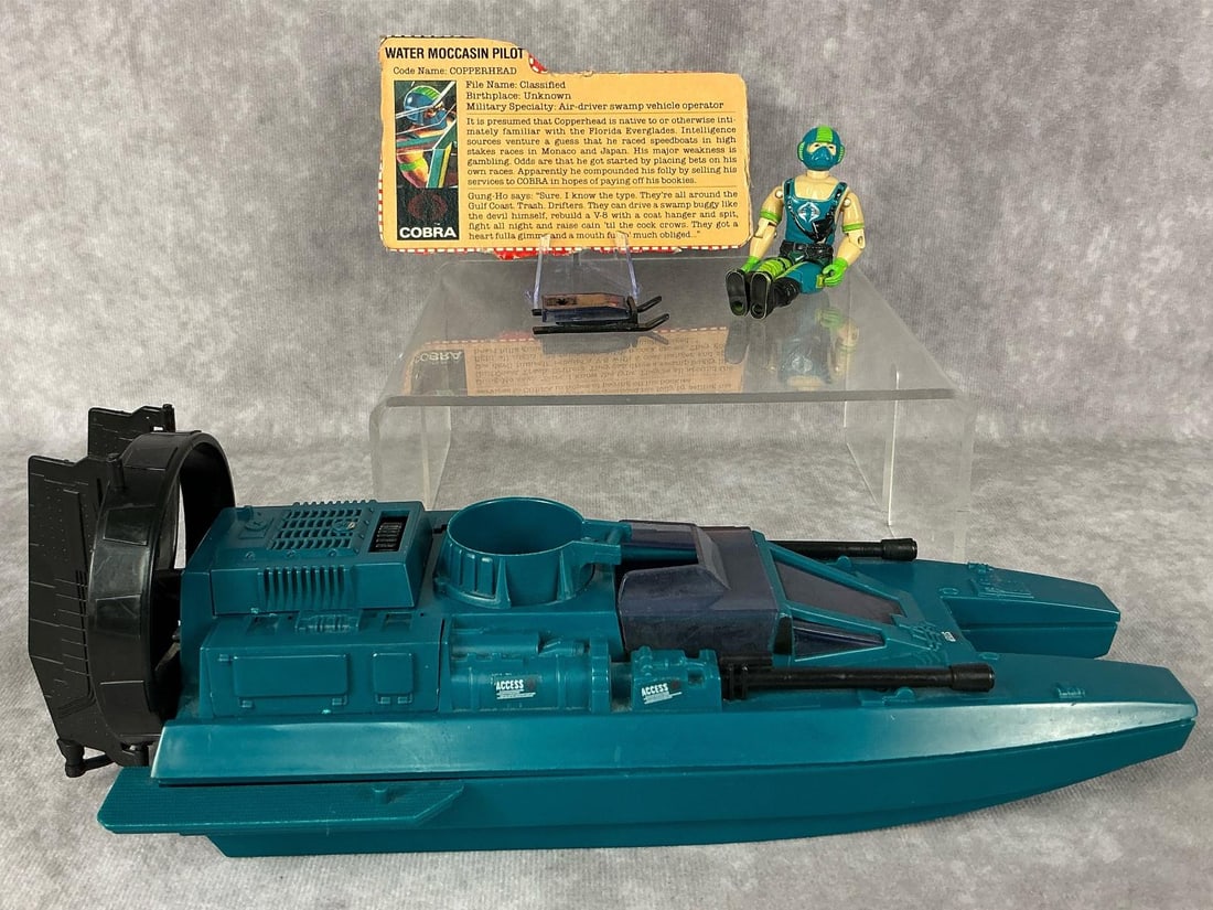 Copperhead With Water Moccasin: 1984 Copperhead G.I. Joe with file card and Water Moccasin vehicle, made by Hasbro in Hong Kong. Figure has tight joints, a slightly loose torso, and some paint loss. Vehicle measures 4.75 inches