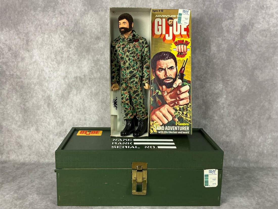G.I. Joe With Footlocker: 1974 Land Adventurer 12 inch G.I. Joe in original box with gun and paperwork, also includes a 1964 wooden footlocker with plastic tray insert. G.I. Joe and original box are in good condition,