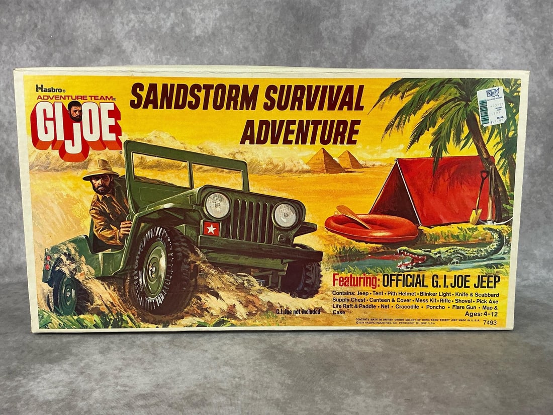 G.I. Joe Jeep: 1974 Sandstorm Survival Adventure in original box. Includes Jeep, life raft and paddle, and more accessories. At one end of box the tape has come loose, otherwise still intact, not opened. Box has a