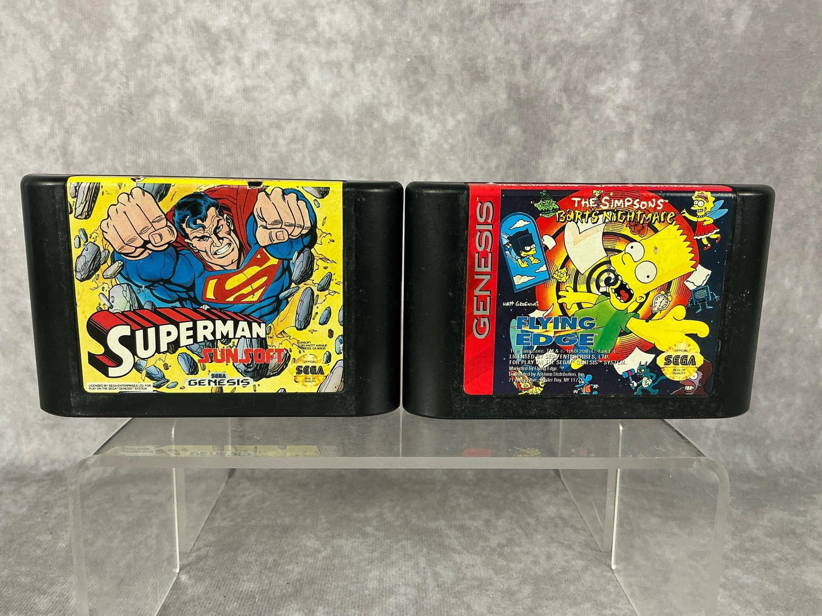 Sega Genesis Games: Two 1990s Sega Genesis games, Superman and The Simpsons Bart’s Nightmare. Both are untested and show wear. Each one measures 4.25 inches wide x 2.75 inches tall.