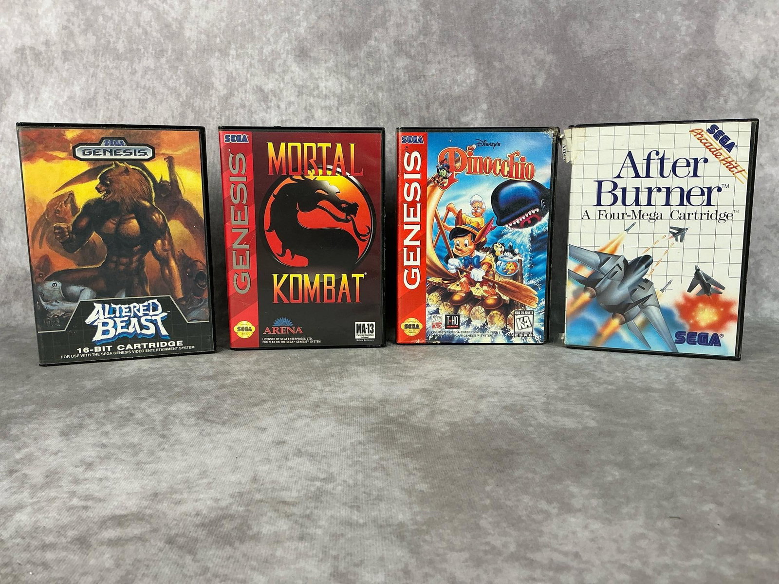 Sega Genesis Games: 1992 Mortal Kombat game in original case with booklet, 1989 Altered Beast game in original case with booklet, 1988 After Burner in original case, and 1996 Disney’s Pinocchio in original case. All