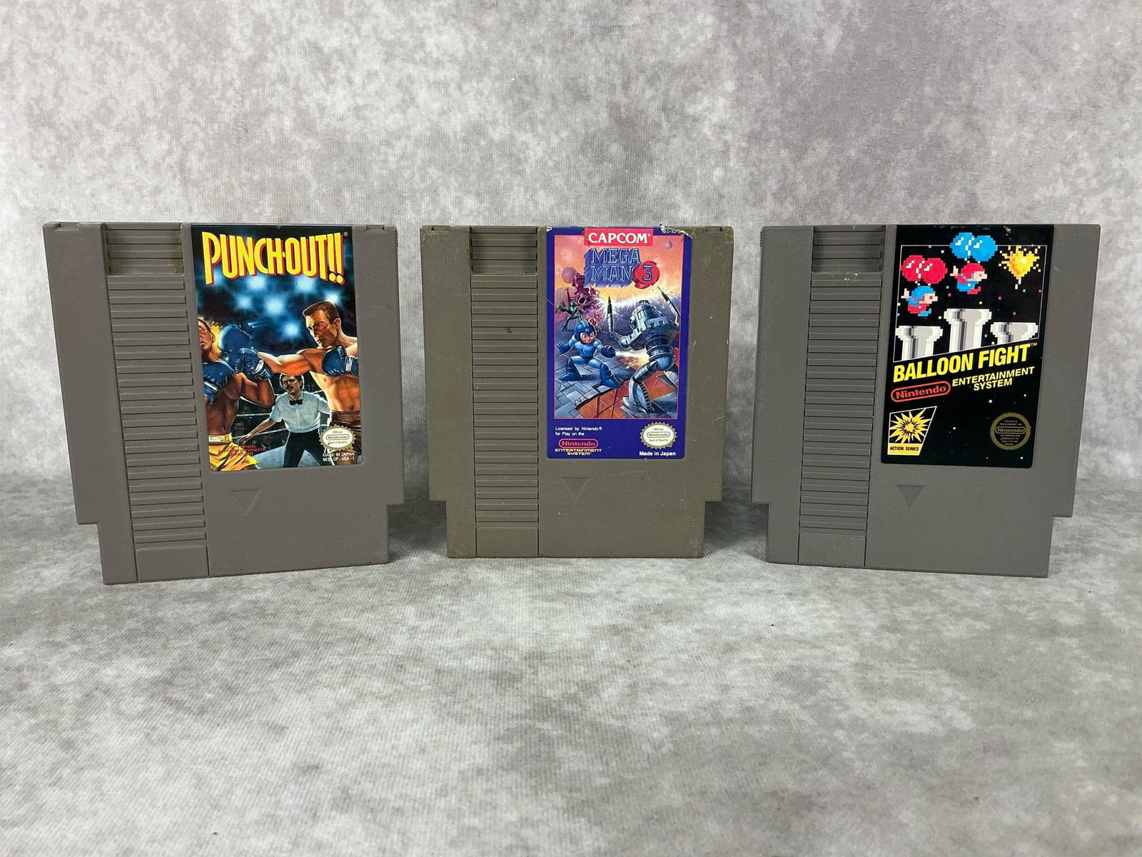 Nintendo Games: Three vintage Nintendo NES games made in Japan. Includes Punchout, Mega Man 3, and Balloon Fight. All games are untested and have wear. Each one measures 4.75 inches wide x 5.25 inches tall.