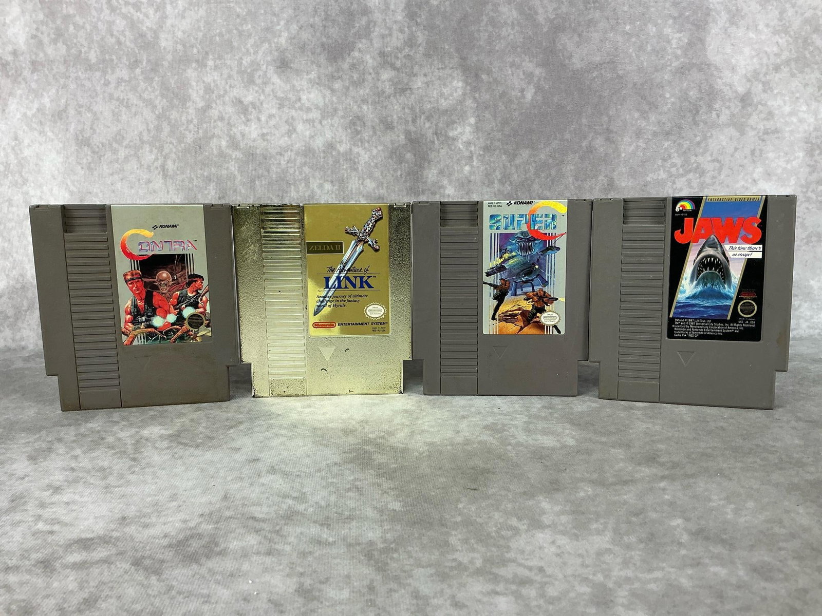 Nintendo Games: Four vintage Nintendo NES games made in Japan. Includes Contra, Zelda II, Jawa, and Super C. All games are untested and have wear. Each one measures 4.75 inches wide x 5.25 inches tall.